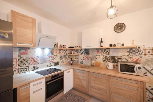 a kitchen with wooden cabinets and a stove top oven at COCO in Pirovac