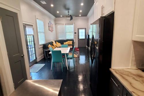 a kitchen and living room with a table and chairs at West End Modern Atlanta 3 Bedroom Bungalow in Atlanta
