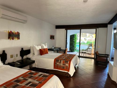 Postel nebo postele na pokoji v ubytování Hotel Hacienda Taboada (Aguas Termales)