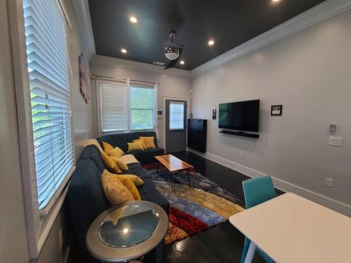 a living room with a couch and a tv at Atlanta World Cup Beltline Bungalow in Atlanta
