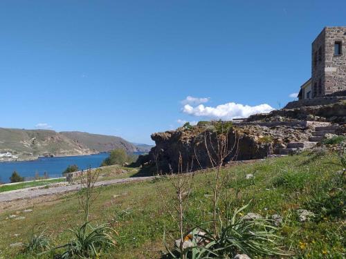 a building on a hill next to a body of water at Seaview Villa in Tavari