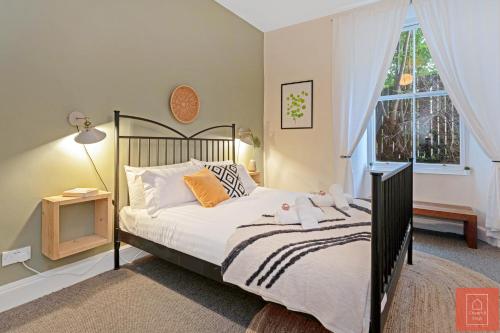 a bedroom with a bed and a window at Cheerful Stays: Spacious Flat in Vibrant Leith in Edinburgh