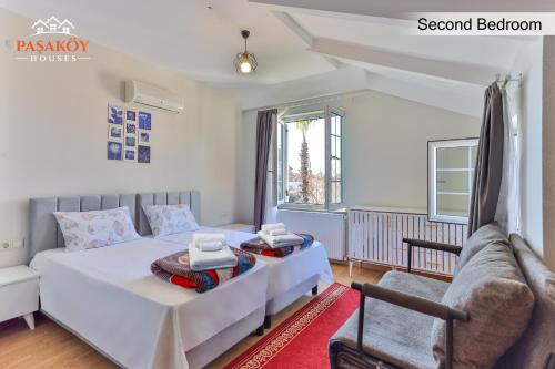 a bedroom with a bed and a couch at Pasaköy Houses in Side