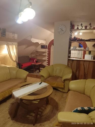 a living room with two couches and a table at Agrohaczow za rzeką Apartament 8-osobowy in Haczów