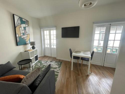 a living room with a couch and a table at RETIRO 401 one-bedroom apartment in Guimarães