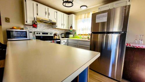 a kitchen with a large stainless steel refrigerator at Pocono House in a private community 4 pools, Lake. in Tobyhanna