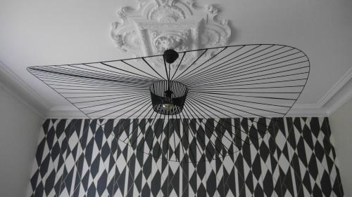 a chandelier hanging from a ceiling in a room at Maison Castel Braz in Pont-Aven
