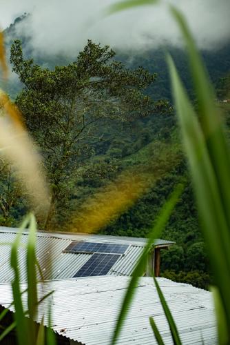 a house with a solar panel on top of a mountain at Cabaña Eco amigable en medio de la montaña. in Pastales