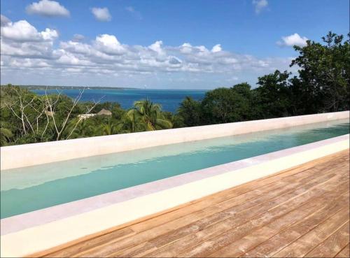 a swimming pool with a view of the ocean at Micaela Bacalar C2 Depto de lujo Vista Laguna in Bacalar