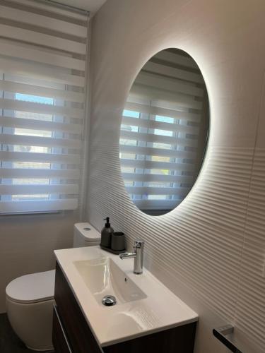 a bathroom with a sink and a mirror at Fogar de Aurora in Portomarin