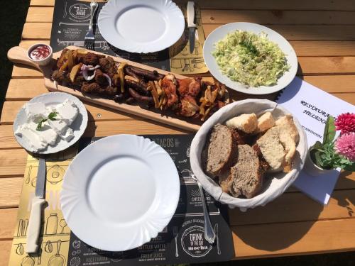 a table with a tray of food and plates of food at Apartment Helena Airport in Podgorica