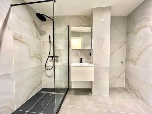 a bathroom with a shower and a sink at Brand-new apartments in the heart of Brussels in Brussels