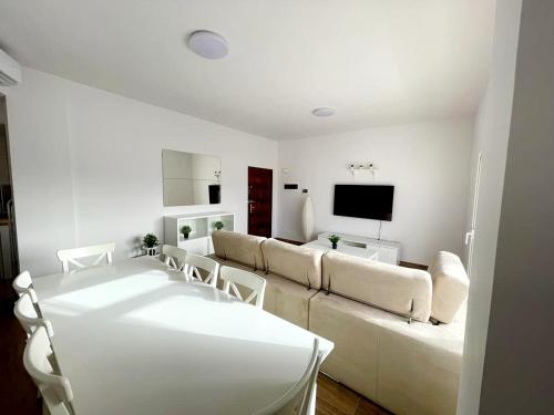a white living room with a couch and chairs at Sky Puerto in Puerto del Rosario
