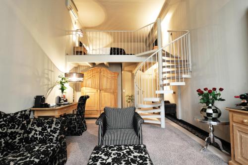 a living room with a couch and a staircase at Stage 47 in Düsseldorf