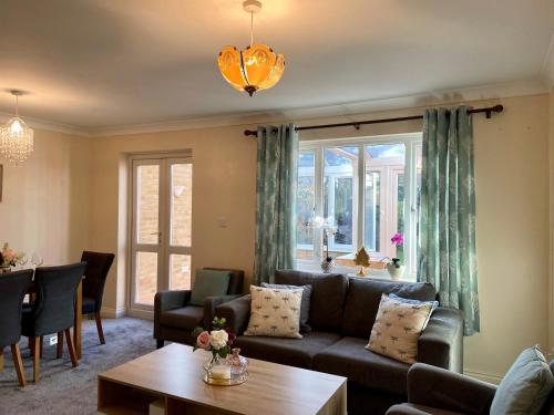 a living room with a couch and a table at Maidstone-Penenden House in Maidstone