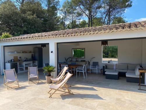 a patio with chairs and a couch and a table at Charming, chic, secluded villa within walking distance from Lorgues in Lorgues