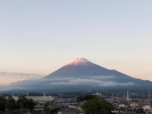 a mountain in the background of a city at 14 Guesthouse Mt.Fuji in Fuji