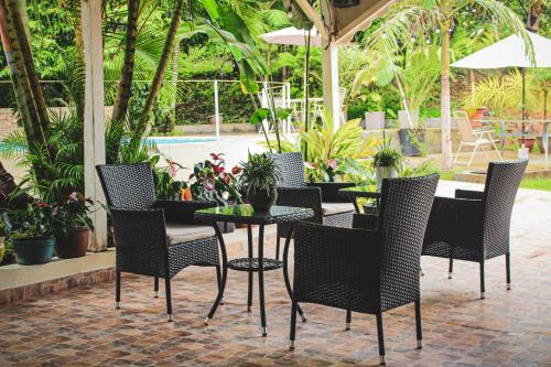a patio with a table and chairs and a pool at Albergue Turístico Gstir in Pozuzo