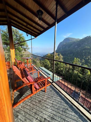 a balcony of a house with a view of the mountains at Country Homes in Ella