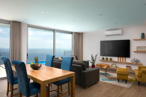 a living room with a couch and a table at Peak A Boo Private Heated Pool and Private Parking in Câmara de Lobos