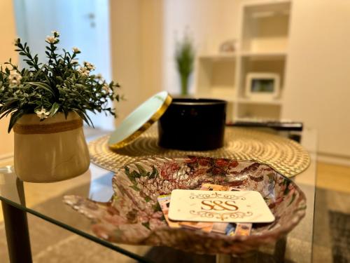 a glass table with a plate and plants on it at New Studio Apartment Timisoara Town in Timişoara