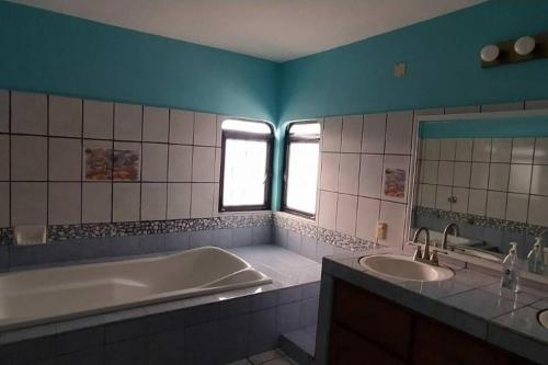 La salle de bains est pourvue d'une baignoire et d'un lavabo. dans l'établissement Casa Las Palmas Barra de Navidad, Jalisco., à Barra de Navidad