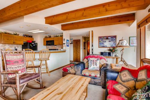 a living room with furniture and a table at Rustic 3 Br Condominium Condo in Crested Butte