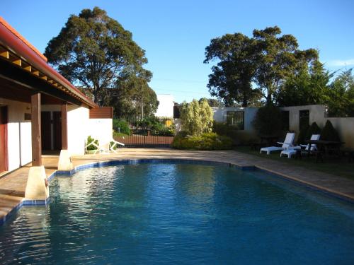 a swimming pool in the backyard of a house at Margaret River Resort in Margaret River Town