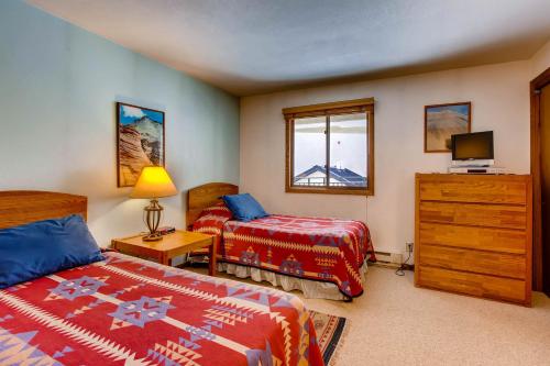 a bedroom with two beds and a television in it at Large 2 Br With Open Floorplan Condo in Crested Butte