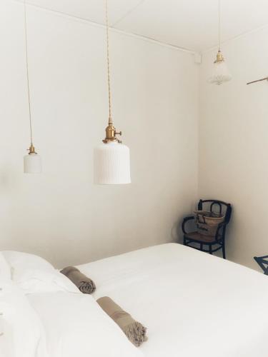 a bedroom with two pendant lights and a bed at Maison Victoire, boutique hôtel - Pointe-à-Pitre in Pointe-à-Pitre