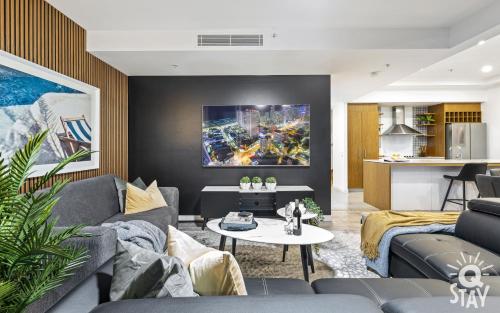 a living room with a couch and a table at Wings Apartments - QStay in Gold Coast