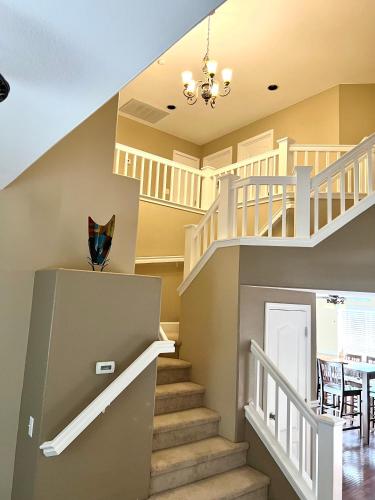 a staircase in a house with a dining room at Serenity in Fresno