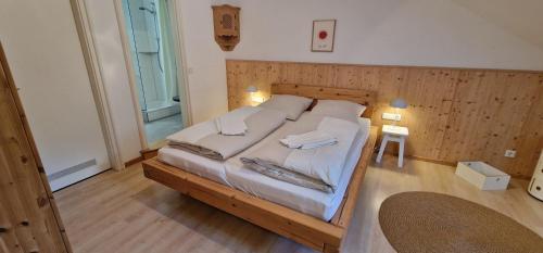 a bedroom with a large bed with white sheets at ciao-aschau Haus zur Burg Ap308 Hohenaschau in Aschau