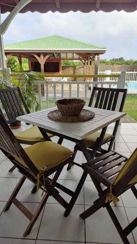 a table and two chairs on a patio at Domaine de Portland in Le Moule