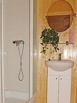 a bathroom with a sink and a mirror at Domki Letniskowe Pikamar in Darlowko