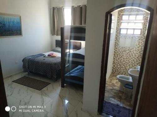 a bedroom with a bunk bed and a mirror at Pousada Praia Grande Solemar in Praia Grande