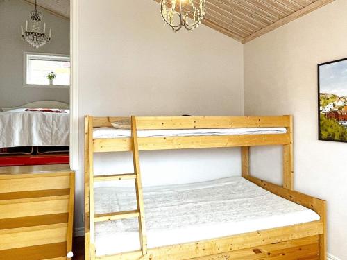 a bedroom with two bunk beds and a chandelier at 8 person holiday home in Uddevalla-By Traum in Uddevalla
