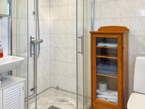 a bathroom with a shower with a glass door at Holiday home HUDDINGE II in Huddinge