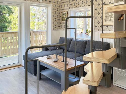 a living room with a couch and a table at Holiday home HUDDINGE II in Huddinge