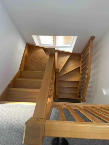 a wooden bunk bed with stairs in a room at 17A Stella house nr Bath in Radstock