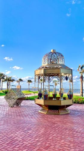 a trolley carousel in a park with palm trees at Porto Said chalet for rent بورتوسعيد بورتو سعيد in Port Said