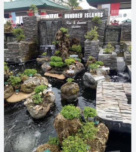 a garden with rocks and plants in front of a building at Lucky one transient 3mins walk from whart in Alaminos