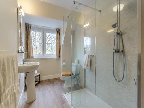 a bathroom with a shower and a sink at Cruives Lodge in Kiltarlty