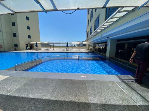 a large swimming pool in the middle of a building at BV1 STUDIO KK CITY CENTRE WITH POOL NEAR Imago in Kota Kinabalu