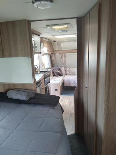 a living room and kitchen in an rv at Caravan Glamping Accommodation in Te Awamutu