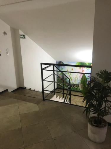 a room with a balcony with a plant in it at Hotel Bolivariano in Ibagué