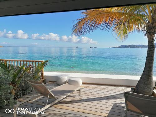 a balcony with a view of the ocean at Love Beach Loft in Marigot