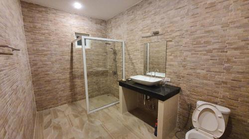 a bathroom with a toilet and a sink and a shower at Family POOL VILLA CHAAM in Cha Am