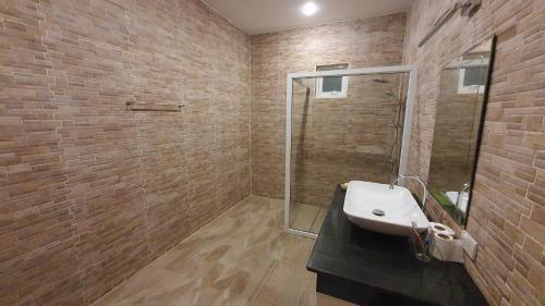 a bathroom with a sink and a glass shower at Family POOL VILLA CHAAM in Cha Am