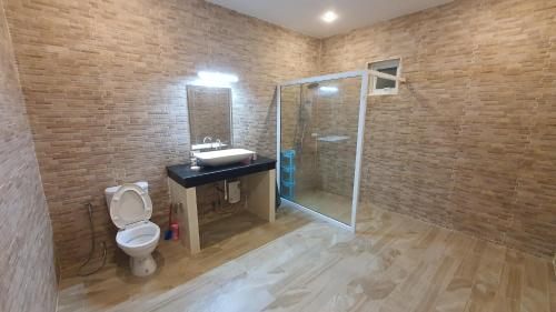 a bathroom with a toilet and a sink and a shower at Family POOL VILLA CHAAM in Cha Am